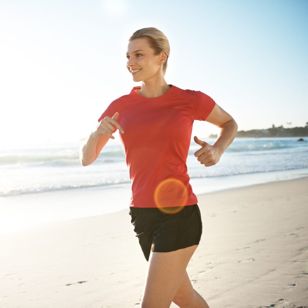 Woman jogging on the beach.