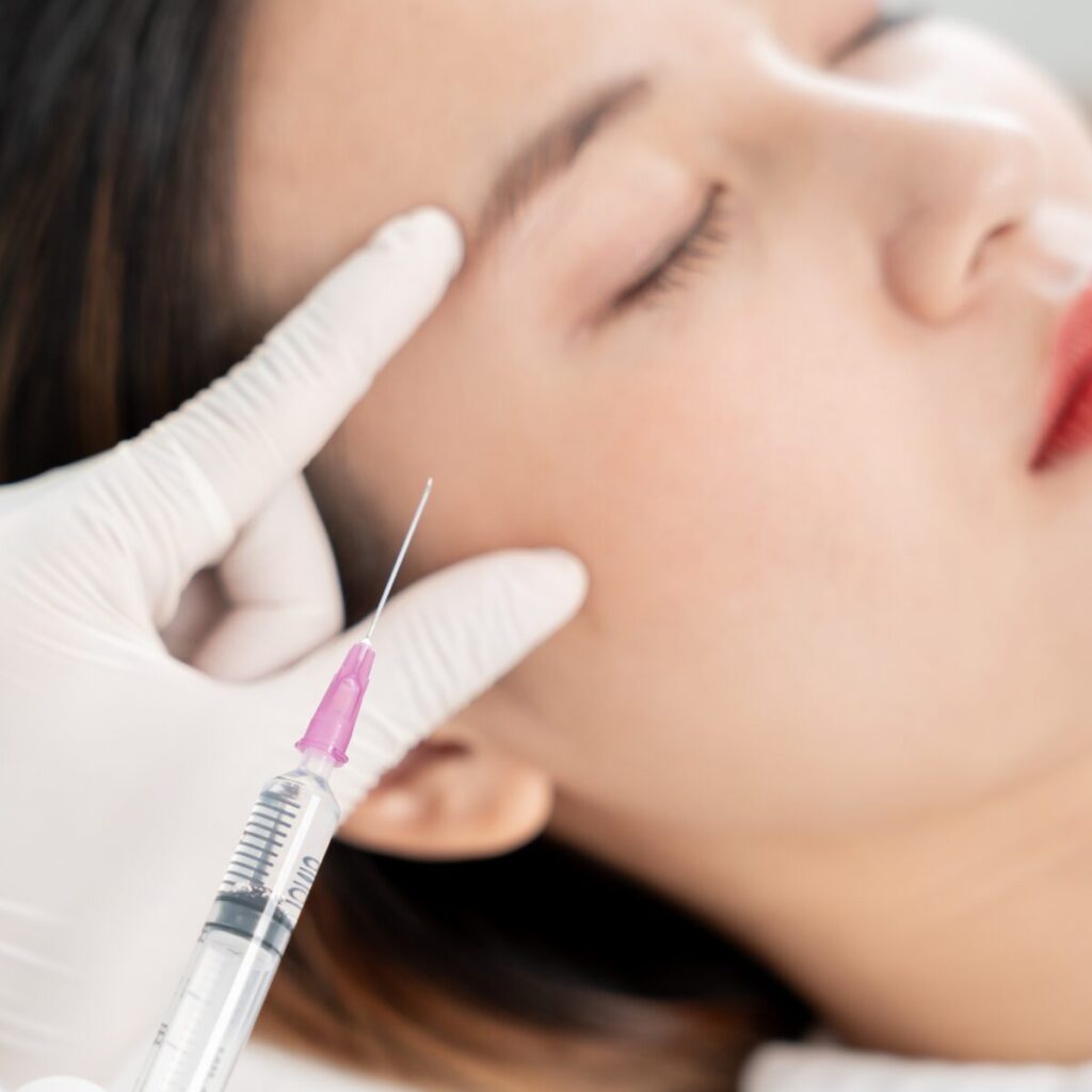 Woman getting injected on her face.