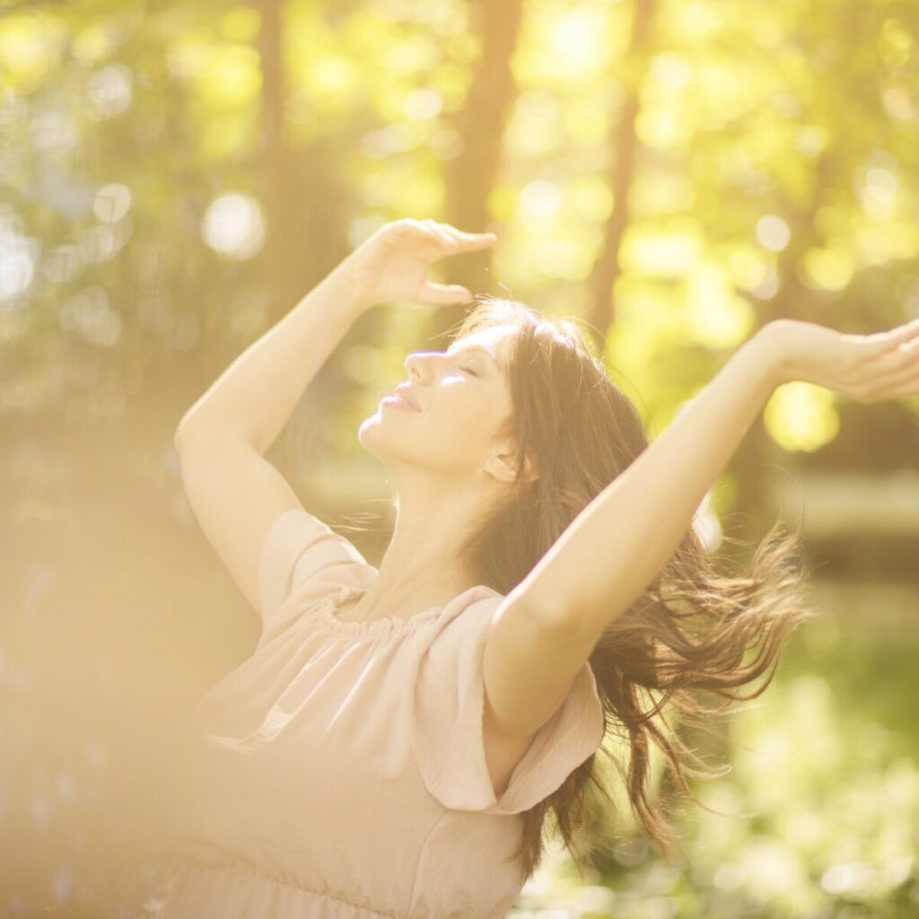 Woman smiling under the sun.