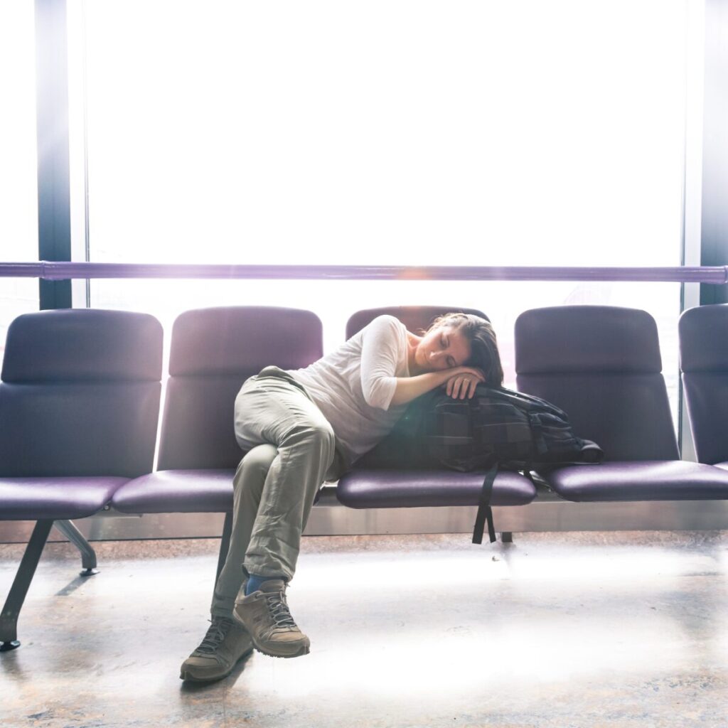 Tired woman sleeping at the airport.