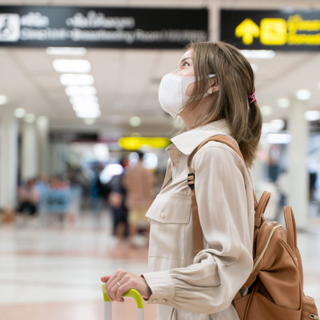 Woman wearing mask at the airport.