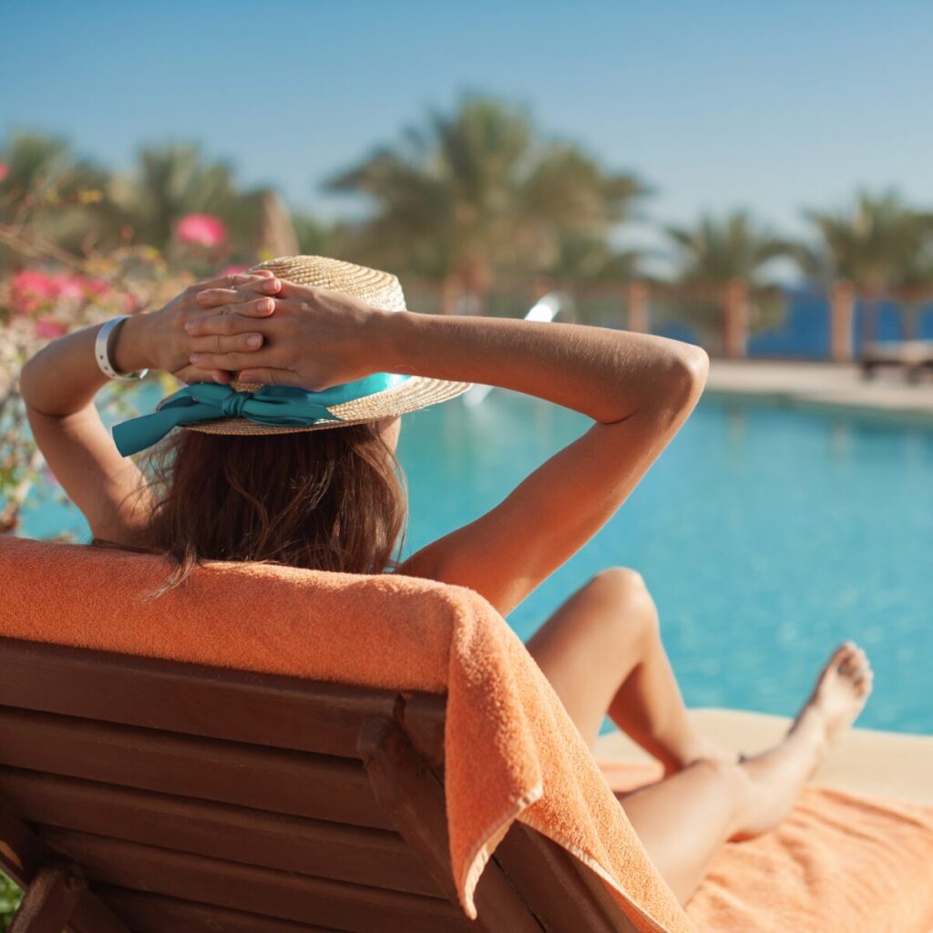 Woman sunbathing by the pool.