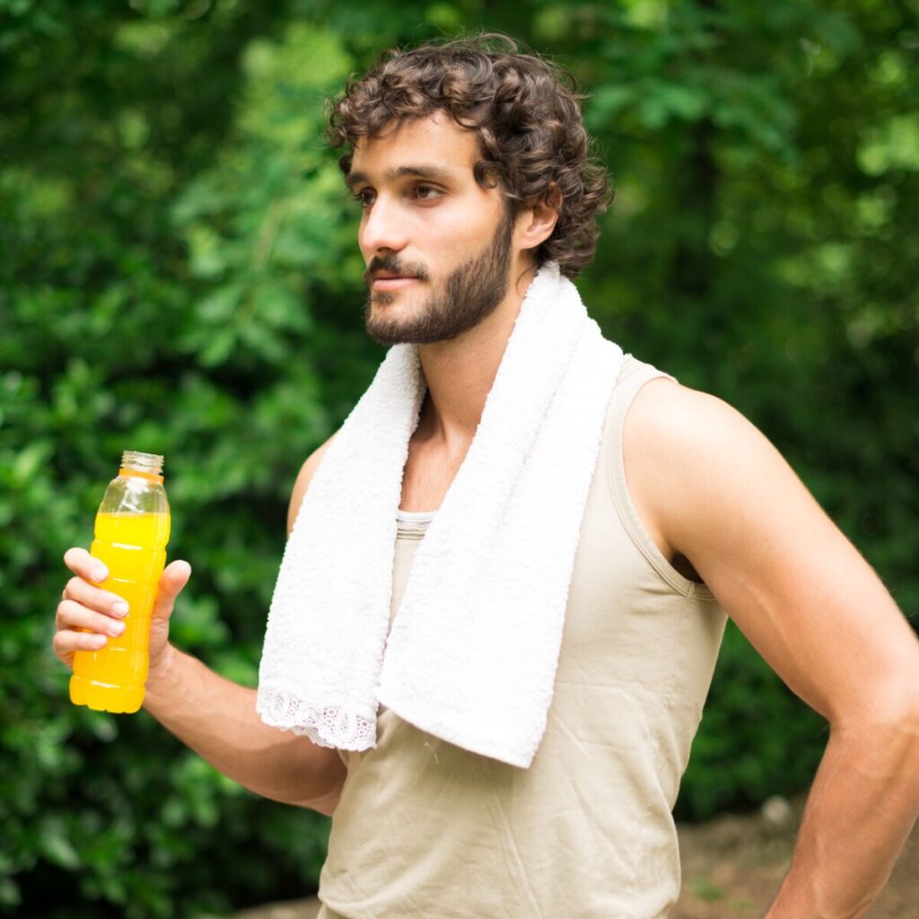 Man holding drink after exercise.