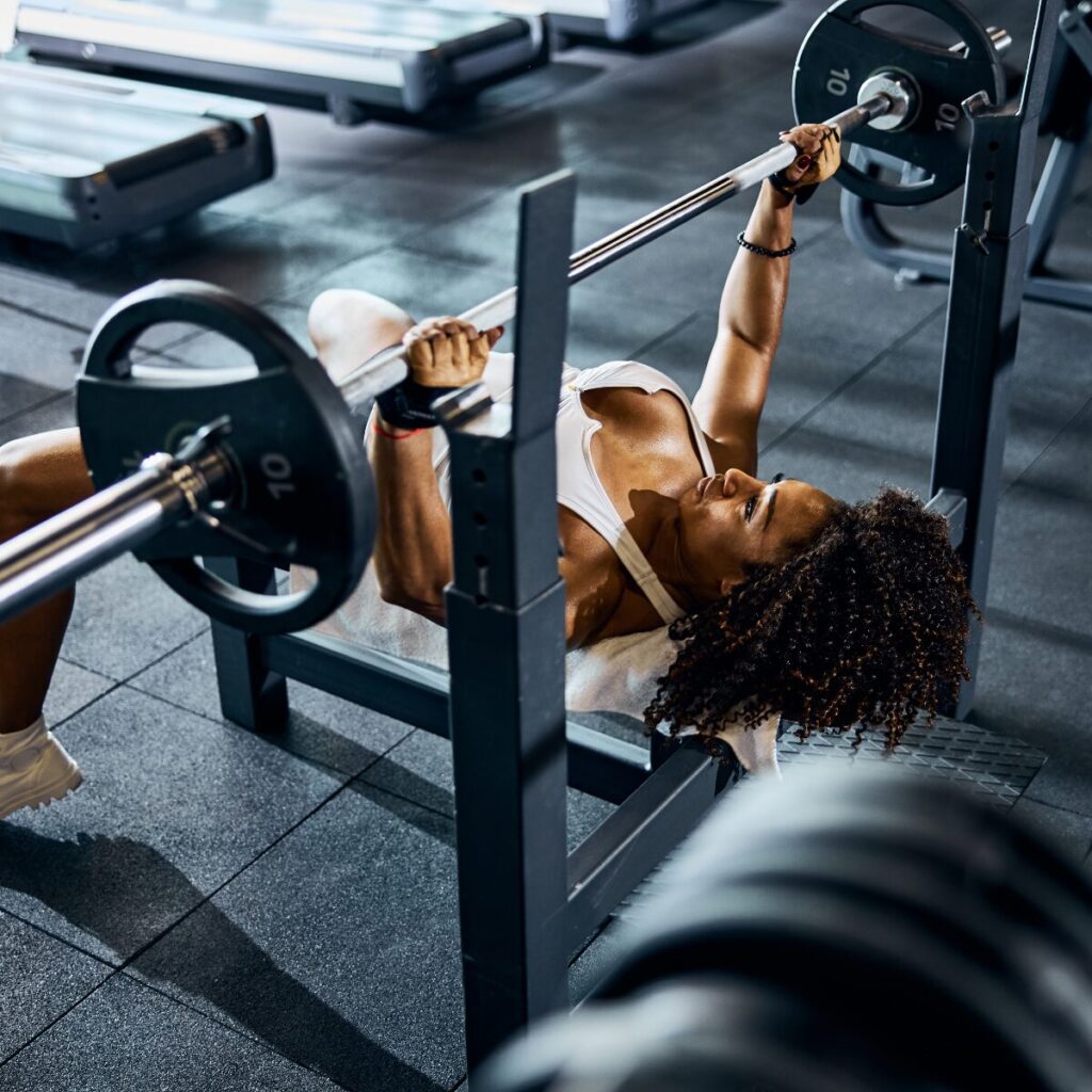 Woman doing bench press.