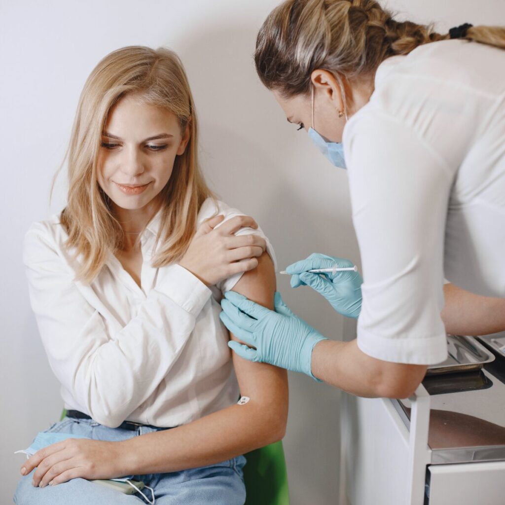 Woman getting an injection on her arm.