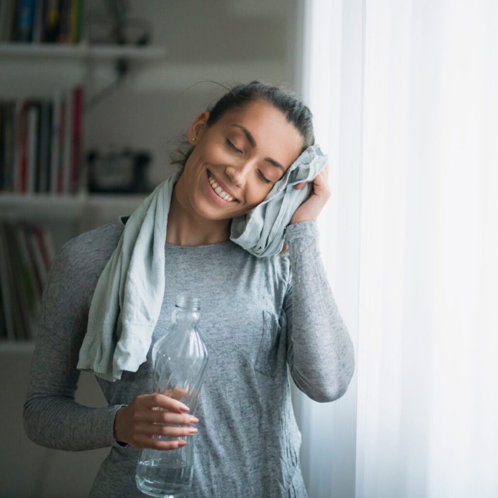 Woman drinking water after workout.
