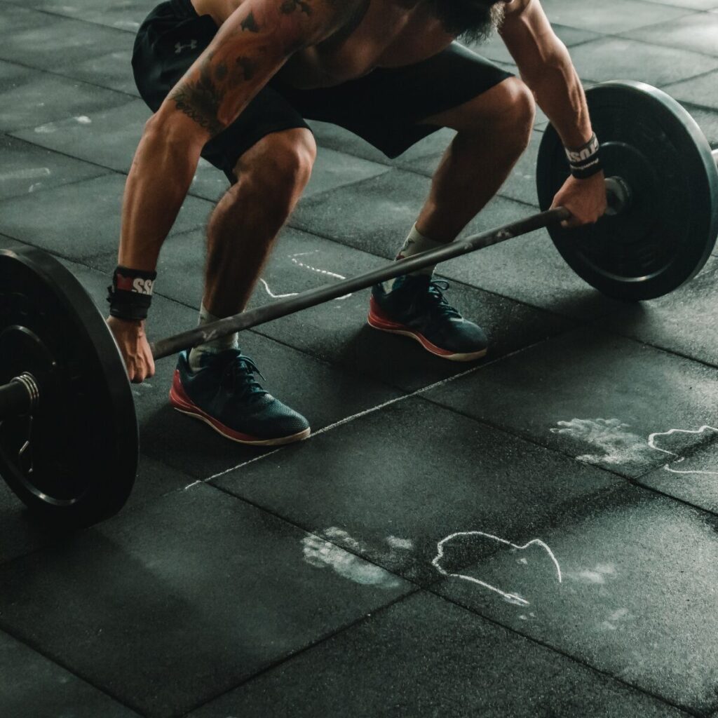 Man preparing to lift weights off the floor.