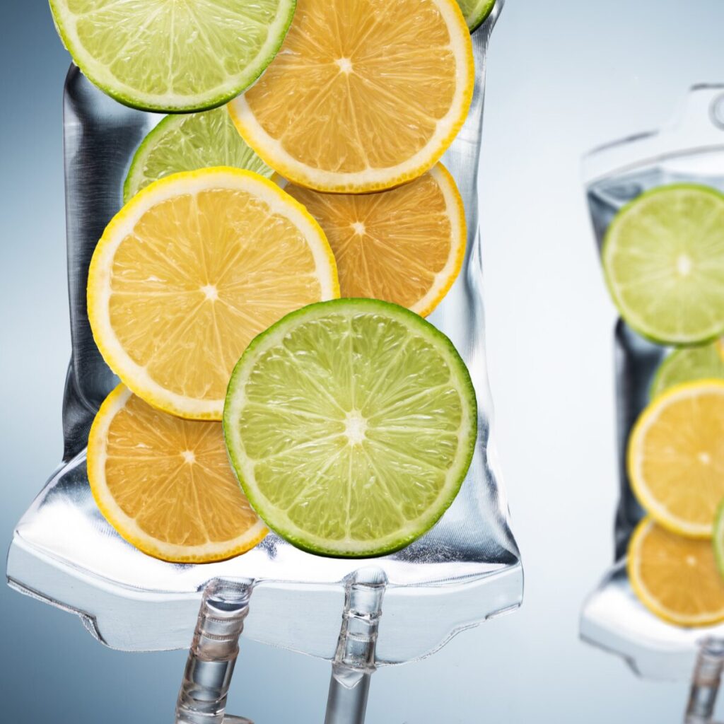 Vitamin IV drip with illustration of citrus fruits.