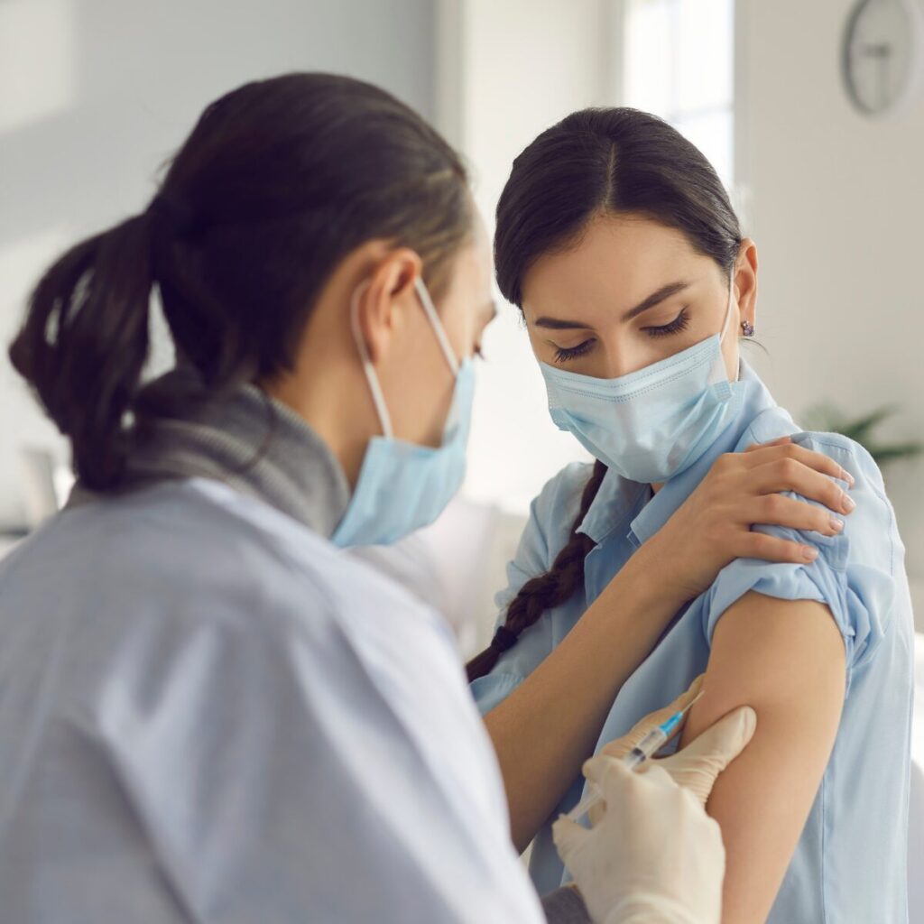 Woman getting an injection in her arm.