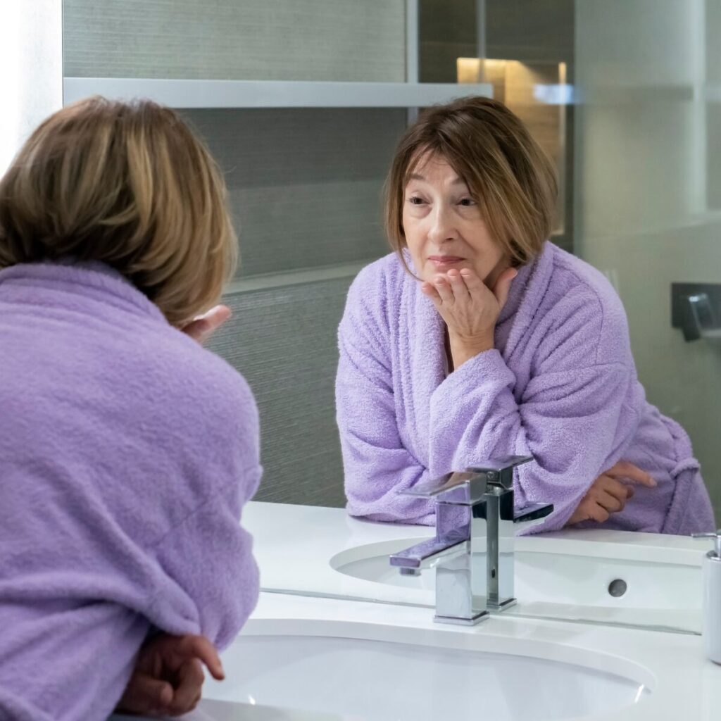 Woman looking at the mirror.