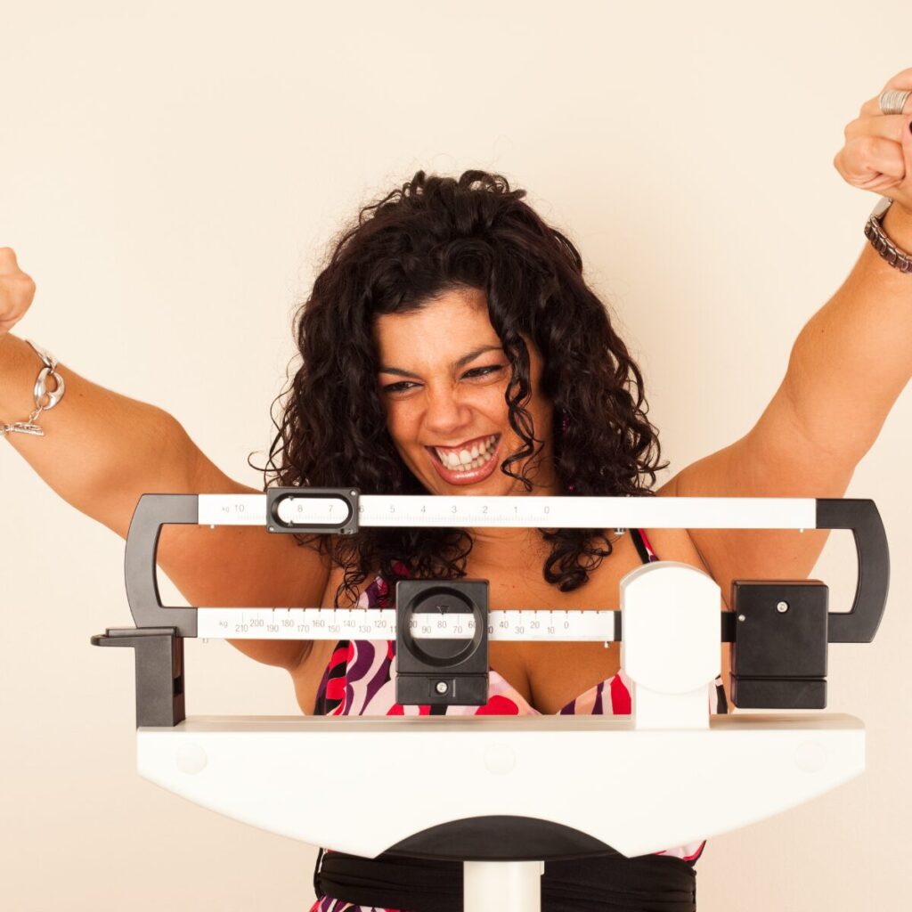 Woman happy about weight loss results.