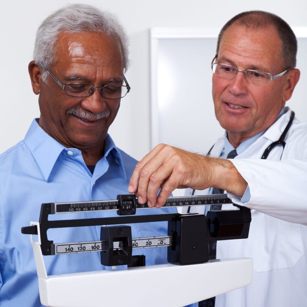 Doctor checking patient's weight.